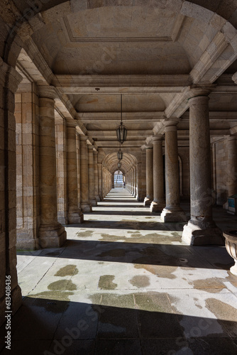 corridor with columns with perspective in vanishing point where light and shadow are mixed