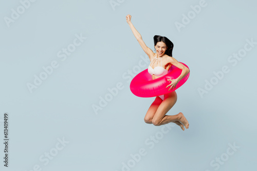 Full body young sexy woman wear swimsuit jump high in inflatable rubber ring rai Fototapet