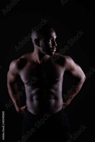 Muscle, body and skin, portrait of black man on dark background with serious face for art aesthetic.