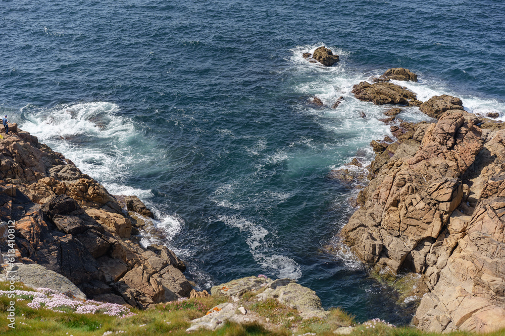 coastal image of foam formed by sea waves crashing against rock formations in La Coruña, Galicia