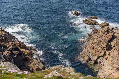 coastal image of foam formed by sea waves crashing against rock formations in La Coruña, Galicia