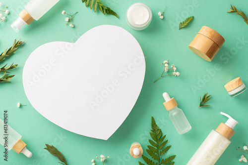 Healthy skincare cosmetics concept. Above view photo of empty heart frame with cosmetic containers and fern, eucalyptus, gypsophila branches on isolated turquoise background with copyspace
