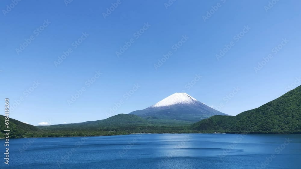 Clear blue sky and green land and mountain around Lake Motosu with Snow covered peak of mount Fuji on spring season landscape, Japan Clear blue sky and green land and mountain around Lake Motosu with Snow covered peak of mount Fuji on spring season landscape, Japan