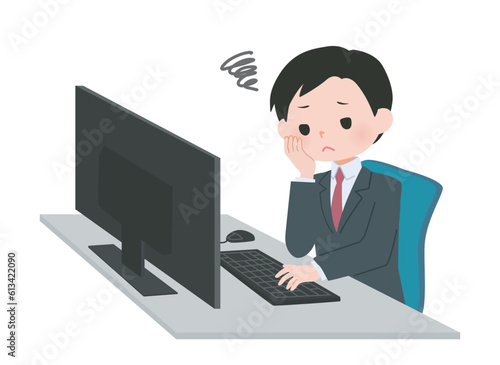 パソコンの前で悩むスーツの男性