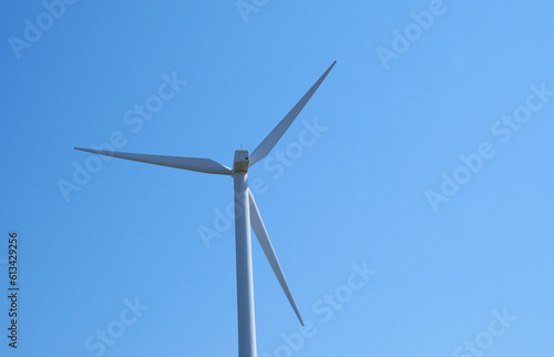 Wind power turbine in the Netherlands against a clear blue sky