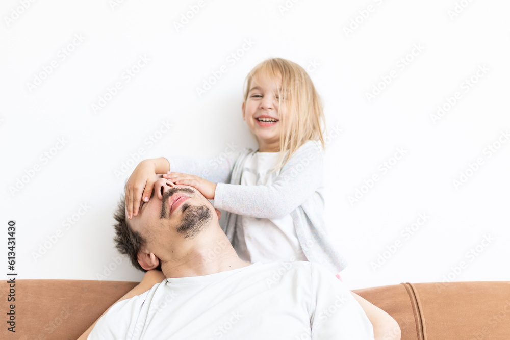 father and toddler daughter playing together. Dad and little girl. Tired dad. Fatherhood. Fathers day father and toddler daughter playing together. Dad and little girl. Tired dad. Fatherhood. Fathers day