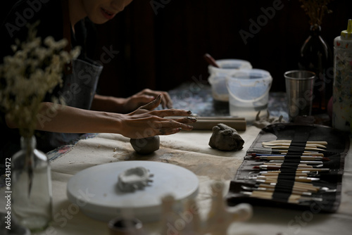 Close-up rear view image of a potter or artist making handcrafted earthenware