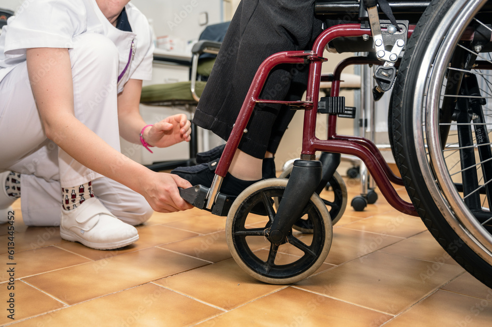 Obraz premium Doctor working with senior woman patient on wheelchair, clinics specialist at work, rehabilitation physiotherapy, unrecognizable elder woman. High quality photo