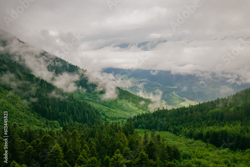 Aerial view of mountains in cloudy foggy sky, aerial shot
