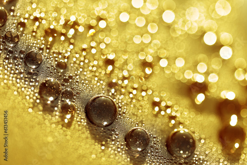Water drops. Macro of water particles on flat surface. Abstract background in yellow tones.