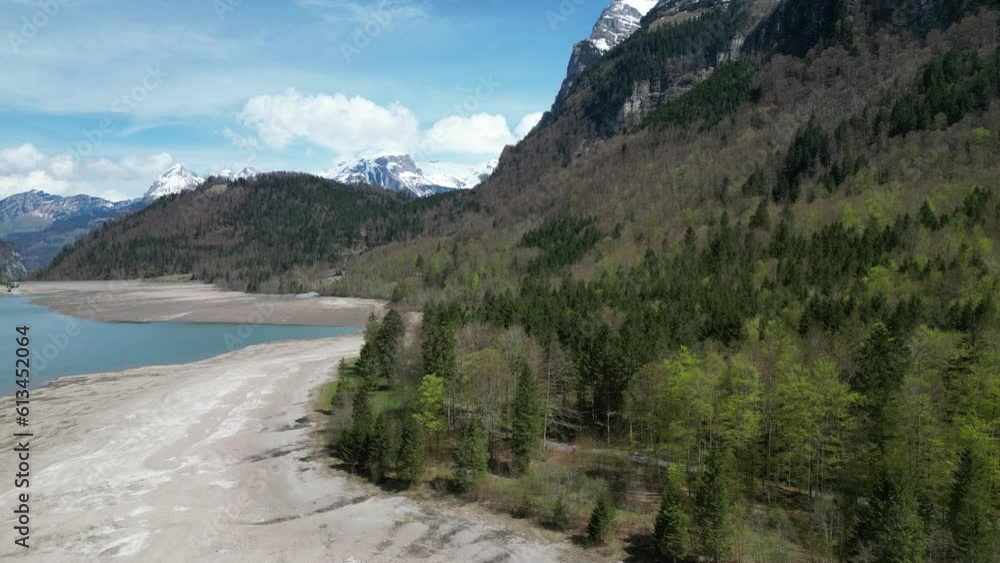Aerial forward view of shoreline of an alpine lake in a fantastic mountain landscape. Switzerland. Real time Aerial forward view of shoreline of an alpine lake in a fantastic mountain landscape. Switzerland. Real time