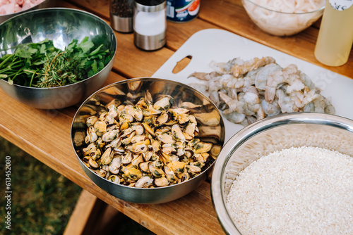 Ingredients for cooking paella on a wooden table. Cooking paella outdoors.