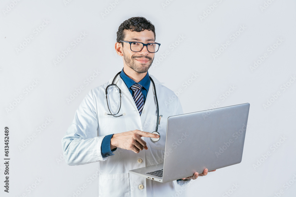 Smiling doctor using and pointing laptop isolated. Young doctor in glasses using laptop and looking at camera. Handsome doctor using laptop isolated Smiling doctor using and pointing laptop isolated. Young doctor in glasses using laptop and looking at camera. Handsome doctor using laptop isolated