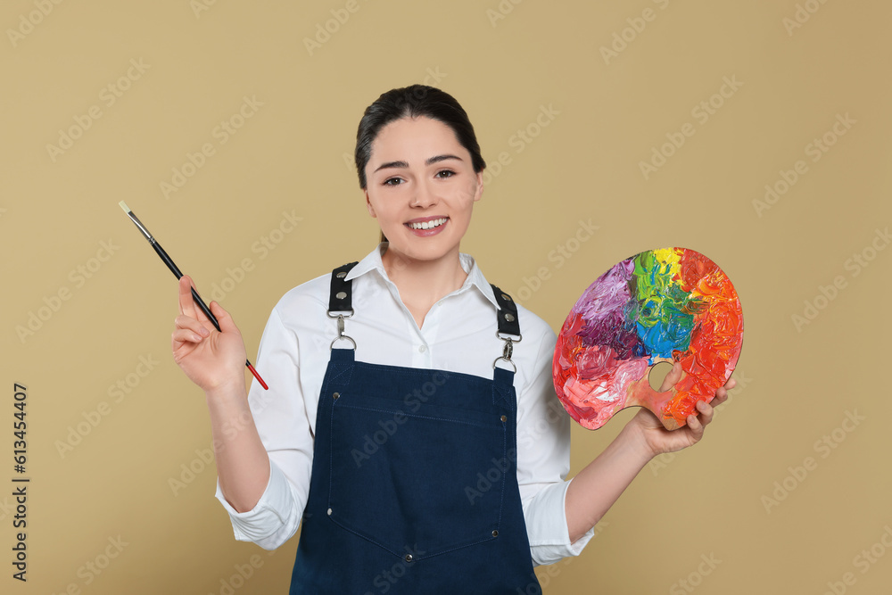 Fototapeta premium Woman with painting tools on beige background. Young artist