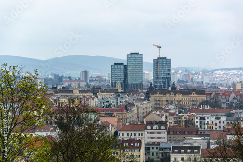 Brno, Czech Republic - Old houses in the city center and three modern high-rise buildings with a crane.