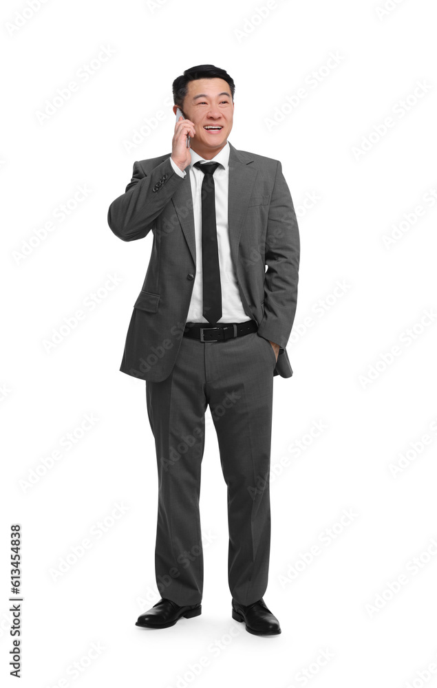 Businessman in suit talking on phone against white background Businessman in suit talking on phone against white background