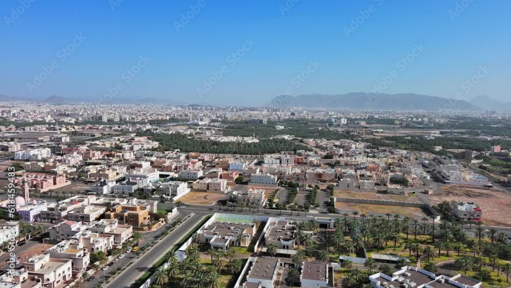 Medina, Saudi Arabia: Aerial shot of famous city in Arabia, city suburb with buildings in Arabic style and palm trees - landscape panorama of Arabian Peninsula from above Medina, Saudi Arabia: Aerial shot of famous city in Arabia, city suburb with buildings in Arabic style and palm trees - landscape panorama of Arabian Peninsula from above