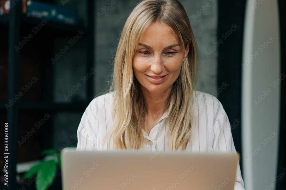 Portrait of a business woman working on a laptop in a coffee shop. Portrait of a business woman working on a laptop in a coffee shop.