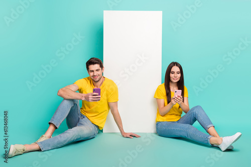 Photo of dreamy addicted husband wife dressed t-shirts surfing modern device empty space isolated turquoise color background