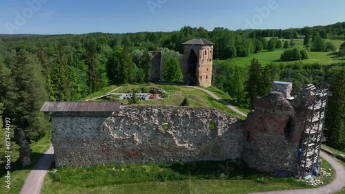 Slowly approaching aerial view of ruins of Vastseliina Episcopal Castle. Estonia. photo