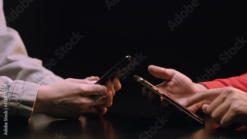 Caucasian Woman and Latino Man Using Cellphones, Slow Motion. Shot with ARRI Alexa in ArriRaw at 120 fps, exported 23.98 fps QuickTime Apple ProRes 422 HQ. photo