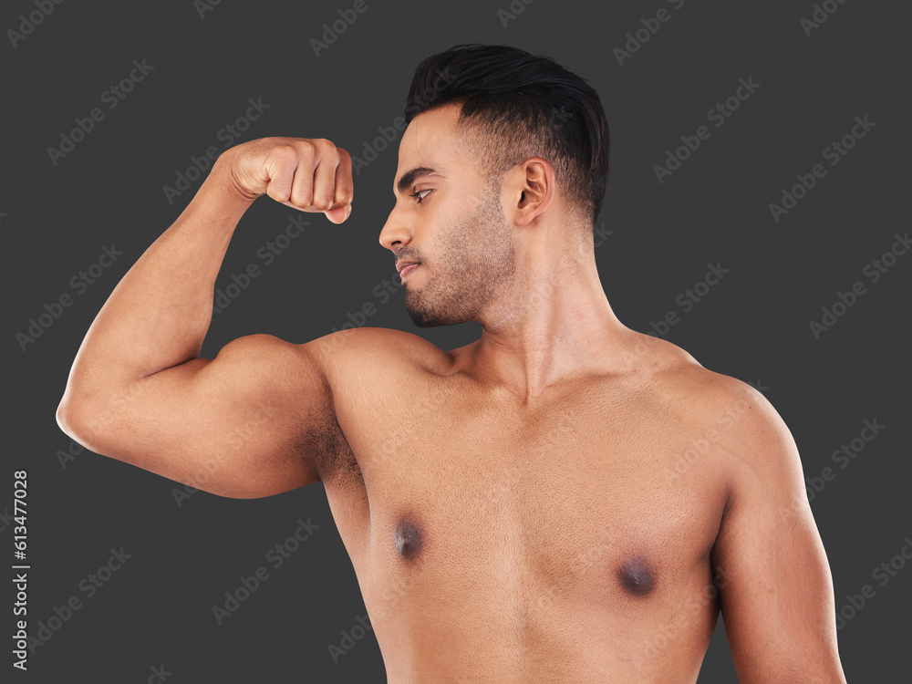 Muscle, fitness and man or bodybuilder flexing after workout for wellness isolated in a studio gray background. Arm, healthy and young athlete or strong person proud of body strength and care Muscle, fitness and man or bodybuilder flexing after workout for wellness isolated in a studio gray background. Arm, healthy and young athlete or strong person proud of body strength and care