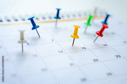 Red push pin in a calender on datebusiness meeting schedule, travel planning and reminder concept.