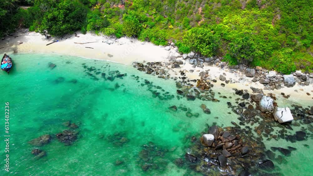 A beach with cream color sand and a lot of rocks half buried in the sand A beach with cream color sand and a lot of rocks half buried in the sand