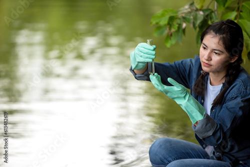 Asian student biology taking and testing sample of natural river water. Experts science women keep water for research analysis in the laboratory. Environmental pollution Concept