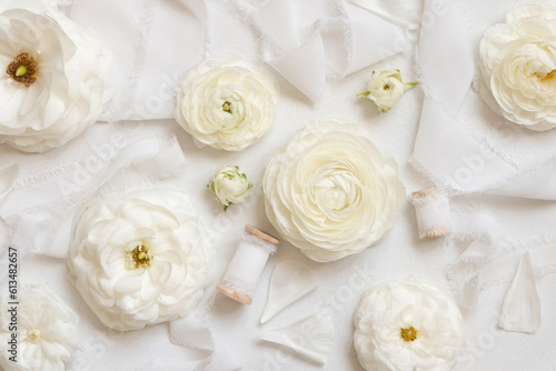 Cream roses and white silk ribbons top view, romantic pastel flatlay
