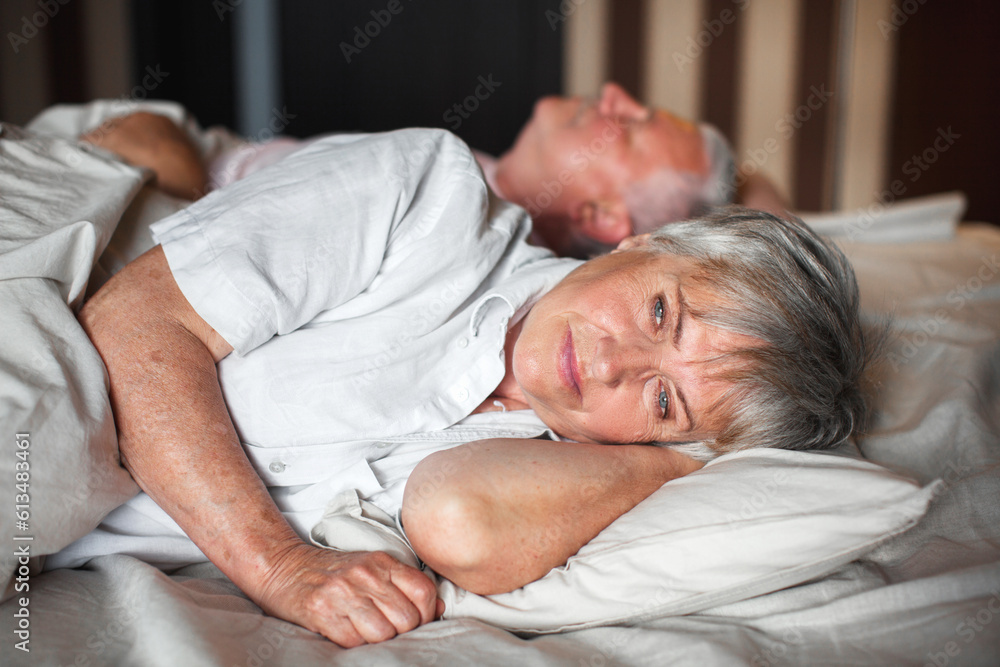 Happy elderly couple wakes up in bed in the morning Happy elderly couple wakes up in bed in the morning