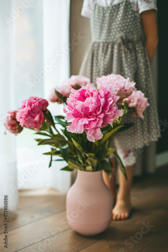 Wallpaper Mural Little girl standing near a big beautiful bouquet of pink peonies Torontodigital.ca