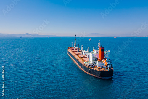 Canvas Print Bulk vessel for dry cargo in anchorage in sea waiting loading in industrial port