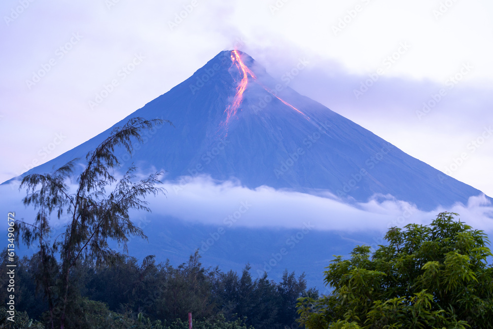 volcano erupting at sunrising spewing lava - obrazy, fototapety, plakaty 