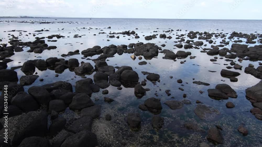 Boulders on the seabed exposed at low tides. Rocky beach with water reflection at Seaholme foreshore, Melbourne VIC Australia. Boulders on the seabed exposed at low tides. Rocky beach with water reflection at Seaholme foreshore, Melbourne VIC Australia.