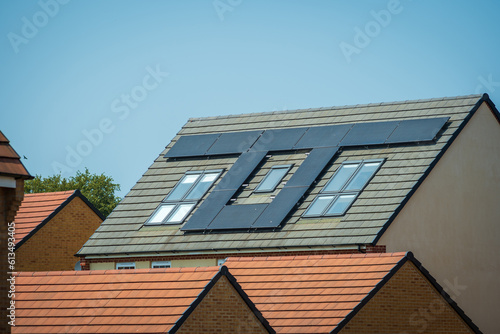 solar panels on roof of new houses in england uk on bright sunny day