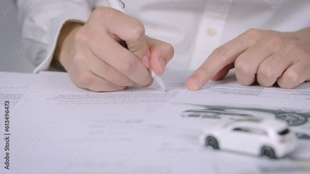 Buyers or sellers who are reading car lease or car insurance contract and signing. Sale agent deal to agreement car loan contract with customer and sign agreement contract, car Insurance concept. Buyers or sellers who are reading car lease or car insurance contract and signing. Sale agent deal to agreement car loan contract with customer and sign agreement contract, car Insurance concept.