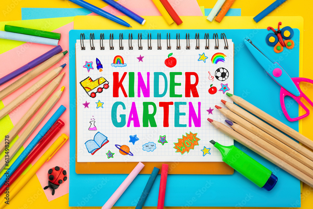 Childish lettering Kindergarten, notebook or scrapbook. Top view flat lay concept. Colored paper, multi-coloured letters, supplies, stationery for Pre-school, nursery school, preschool educational Childish lettering Kindergarten, notebook or scrapbook. Top view flat lay concept. Colored paper, multi-coloured letters, supplies, stationery for Pre-school, nursery school, preschool educational