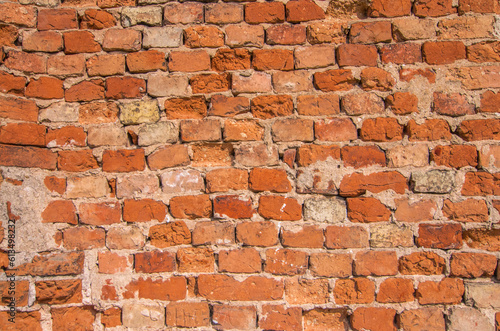 Brick wall  cracked plaster  cracks  texture for mock up. Rustic old red surface. Empty background