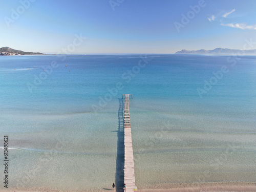 Aerial front view of a wooden dock over the sea of a beach of Majorca. Lifestyle, summer, holiday concept	