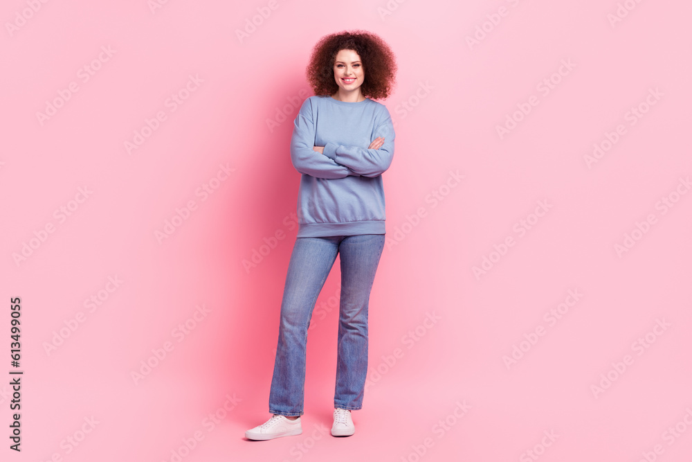 Full length photo of confident cool woman dressed blue sweatshirt arms crossed isolated pink color background Full length photo of confident cool woman dressed blue sweatshirt arms crossed isolated pink color background