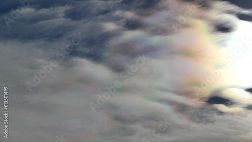 Natural blue sky with colorful decorative clouds moving very slowly - Cloud iridescence, irisation around sun. Observed in warm, sunny, windy autumn weather with mountain winds on October in Poland.