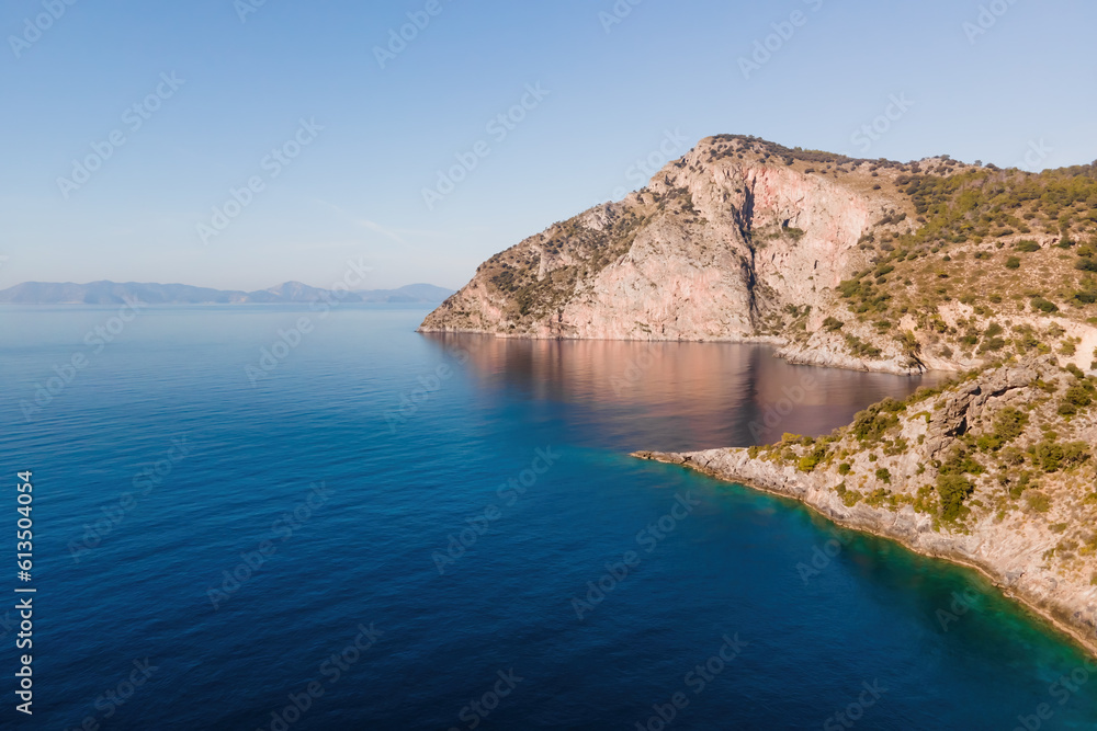 Aegean coast of Turkey with rocky shore with deep blue water. aerial wide shot