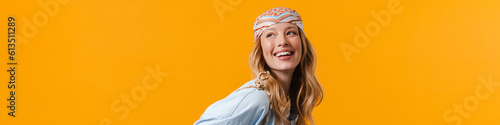 Young blonde woman wearing bandanna smiling and looking upwards photo