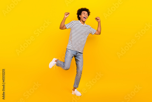 Full body photo of winner crazy victory yelling guy fists up hooray celebrate support football club fan isolated on yellow color background © deagreez