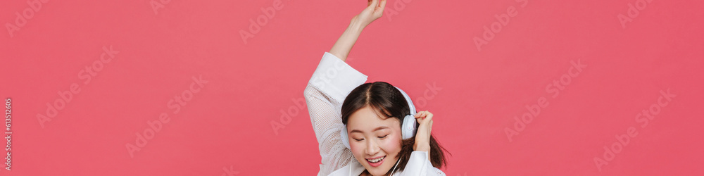 Young cute smiling asian girl in headphones with closed eyes Young cute smiling asian girl in headphones with closed eyes