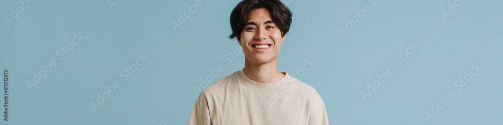 Young handsome smiling asian boy with hands in pockets Young handsome smiling asian boy with hands in pockets