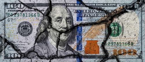 Hundred dollar bill with cracks. US dollar banknote broken into pieces.