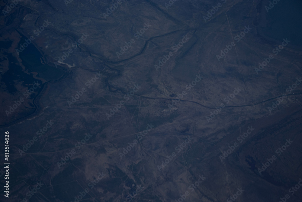 A view of the mountains from the height of an airplane. Beautiful scenery of nature, the beauty of the mountains.