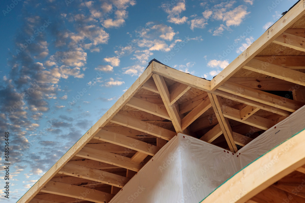 Corner of a house with eaves beams planks wooden rafters is under